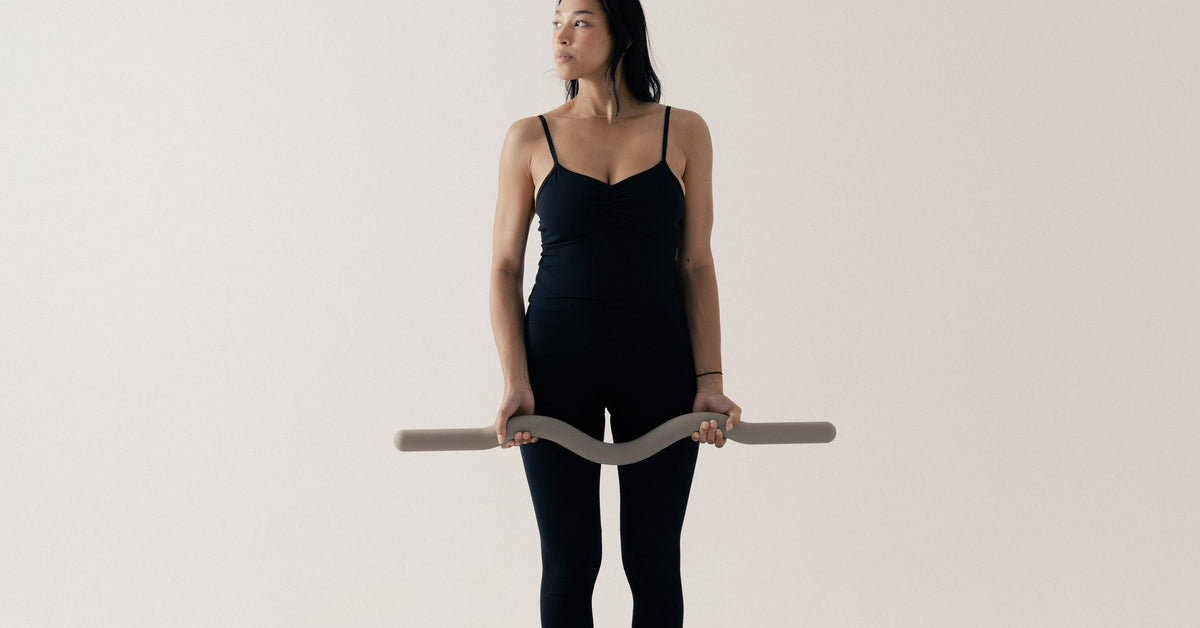 Standing morning Pilates session with a bar