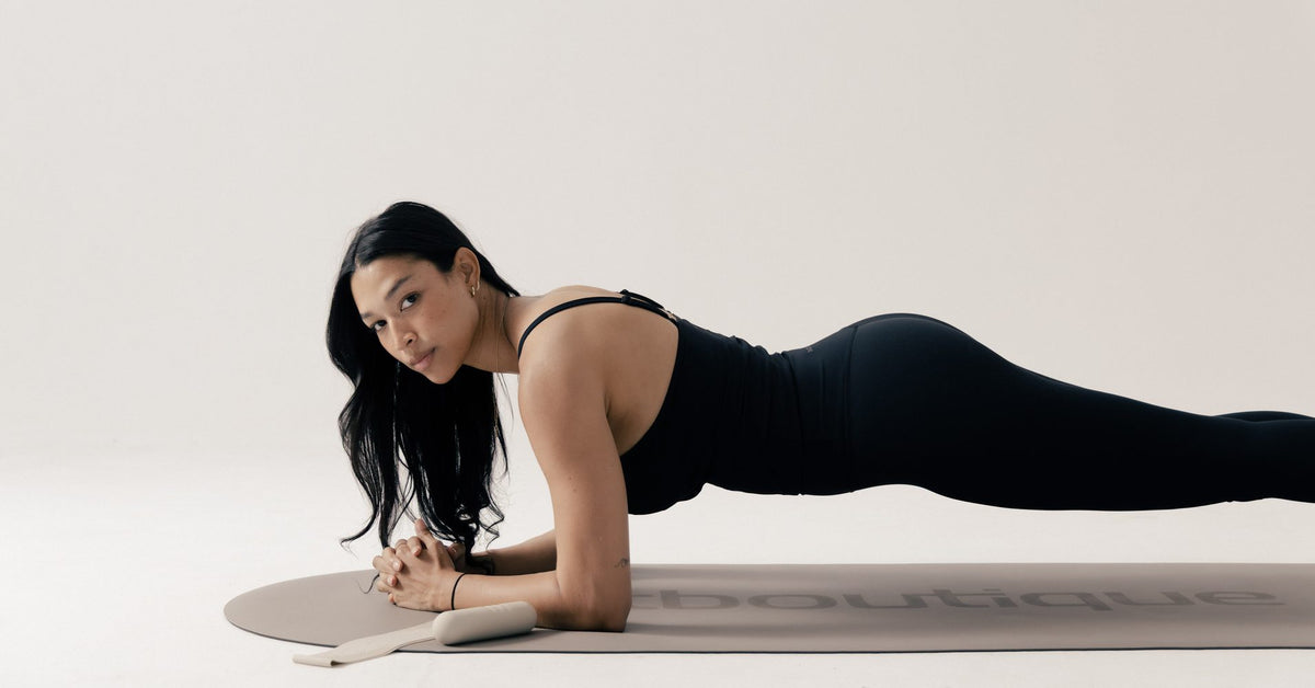 Forearm plank on a FitBoutique mat during a weekly routine