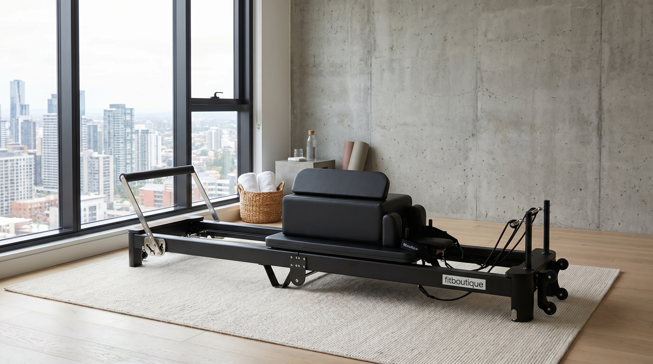 FitBoutique Onyx Fold reformer set up in a modern apartment living space