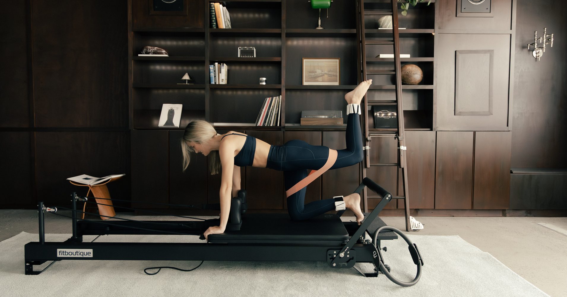 Kneeling kickback with a resistance band on a FitBoutique reformer